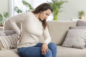A young woman suffer with lower back pain