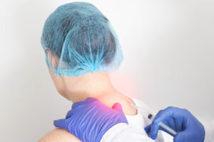 Doctor giving trigger point injections to patient