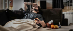 Young man suffering from migraine at home
