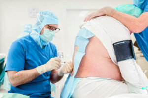 Anesthesiologist doing a spinal block epidural on a patient just before the operation. Doctor giving anesthesia into the back a patient before the surgery.
