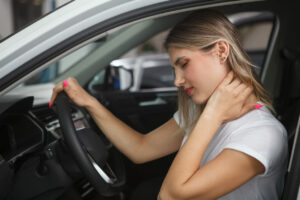 A Woman having neck pain due to car accident pain.