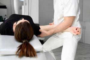 An image of a chiropractor performing bone adjustments in a clinic setting.