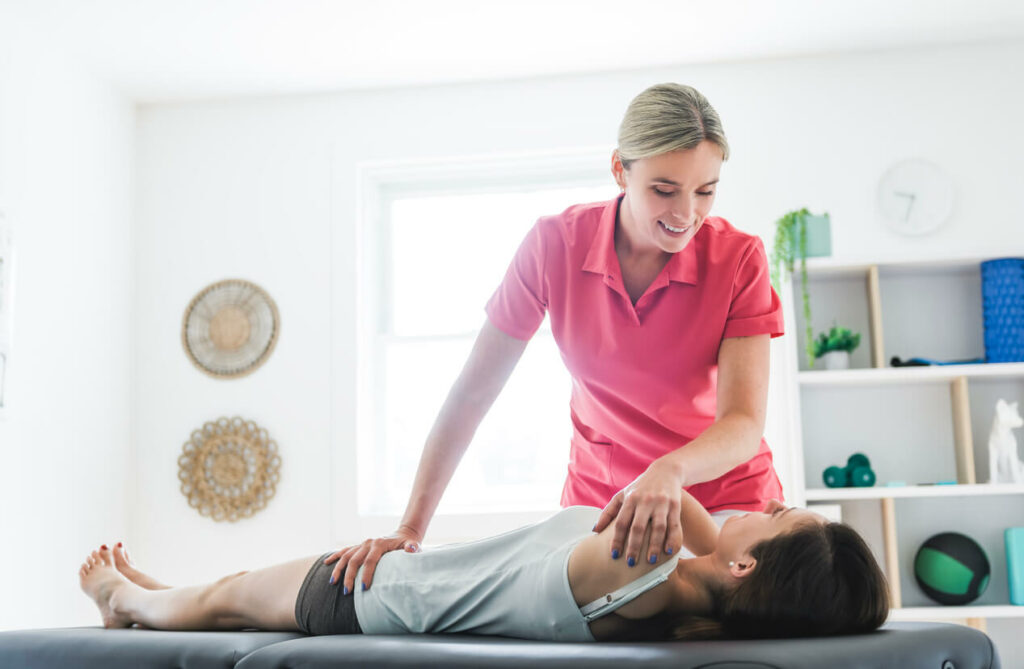 Modern rehabilitation physiotherapy clinic with professional chiropractor and client.