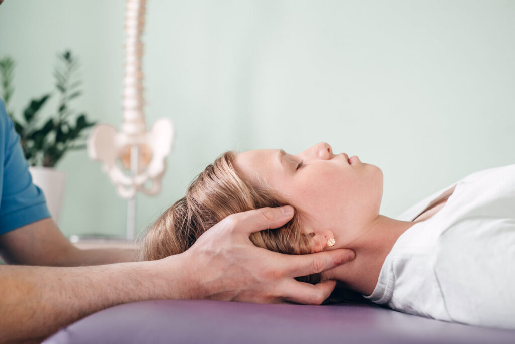 Chiropractor Treating a Woman's Headache